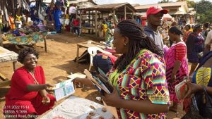 OPIC distributing flyers at the Bangem market